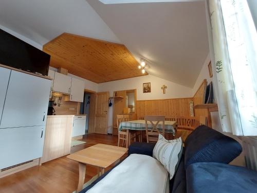 a living room and kitchen with a couch and a table at Einkehrhof Poggau in Reinsberg