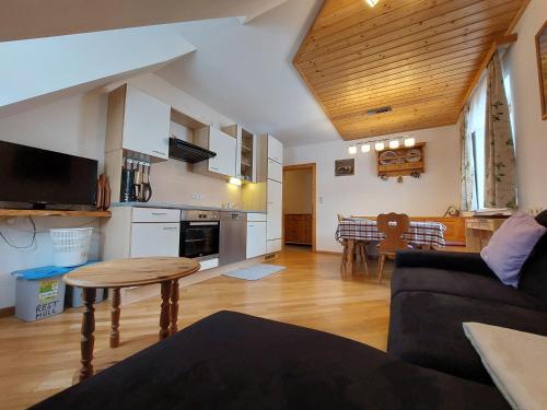 a living room with a couch and a table at Einkehrhof Poggau in Reinsberg
