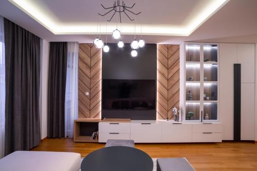 a living room with a flat screen tv on a wall at Apartman G8 Deluxe in Pale