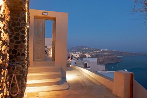 a view of the ocean from a house with stairs at Ikia Kriton in Imerovigli