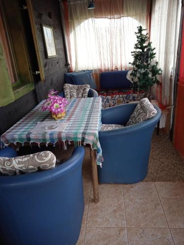 a living room with a table and a couch at Holiday Home Vila Milka in Kremna