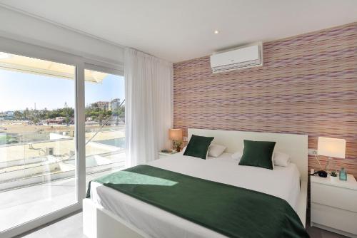 a bedroom with a large bed and a large window at Apartment Nueva Suecia CR715 by VillaGranCanaria in San Agustin