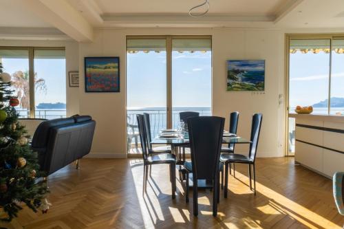 a dining room with a christmas tree and a table and chairs at 3-Br apartment exceptional sea view by the beaches in Cannes