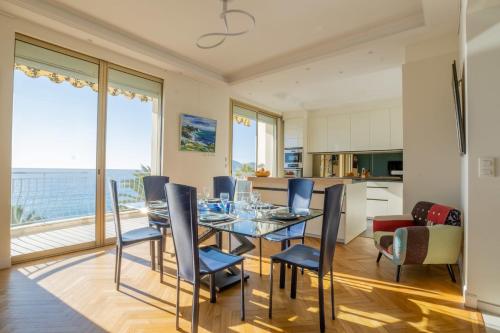 a kitchen and dining room with a table and chairs at 3-Br apartment exceptional sea view by the beaches in Cannes