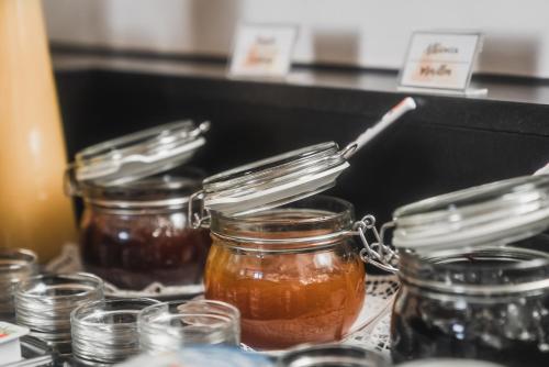 a group of jars of honey on a table at Hotel Villa Waldheim in San Candido
