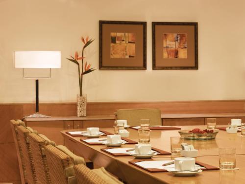 a conference room with a long table and chairs at Trident Chennai in Chennai