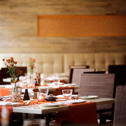 a long dining room with tables and chairs at Trident Chennai in Chennai