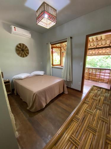 Tempat tidur dalam kamar di Pousada Vilarejo