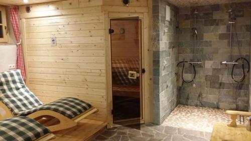 a bathroom with a shower with two chairs in it at Mobilheim Seezauber in Uttendorf