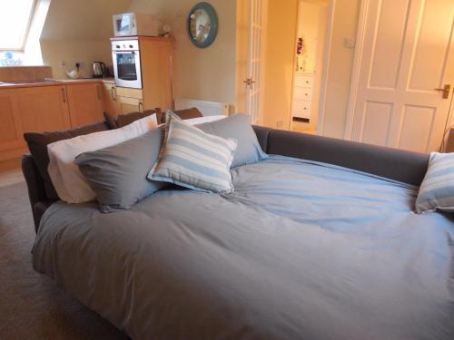 a couch with pillows on it in a kitchen at Robin's Rest in Auchterarder