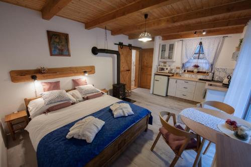 a bedroom with a large bed and a kitchen at Stodola Harrachov in Harrachov