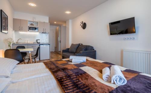 a bedroom with a large bed and a living room at GVC 240 New Gudauri in Gudauri