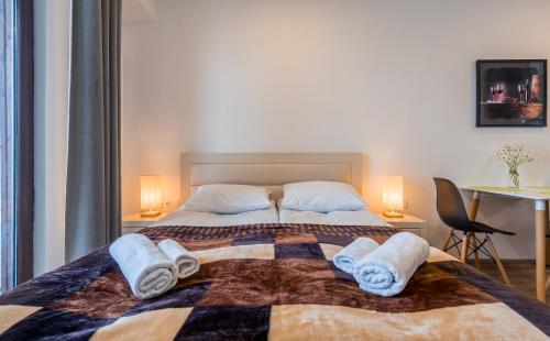 a bedroom with a bed with towels on it at GVC 240 New Gudauri in Gudauri