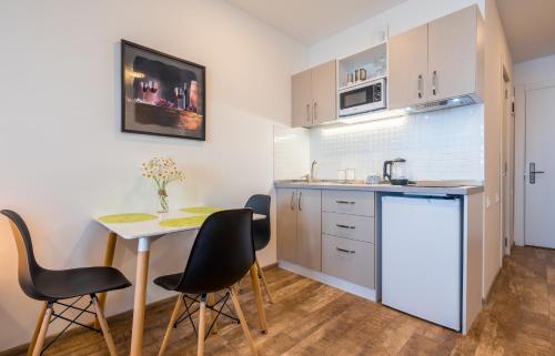 a small kitchen with a table and chairs in a room at GVC 240 New Gudauri in Gudauri