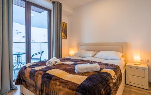 a bedroom with a bed with two towels on it at GVC 240-2 New Gudauri in Gudauri