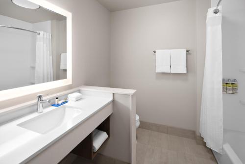 a white bathroom with a sink and a mirror at Holiday Inn Express & Suites - Elkhorn - Lake Geneva Area by IHG in Elkhorn