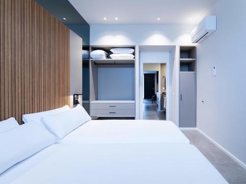 a bedroom with a large white bed and a closet at Zuia Suites in Murguía