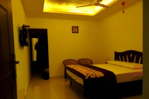 a bedroom with a bed in a room with a ceiling at Vibgyor Villa in Munnar