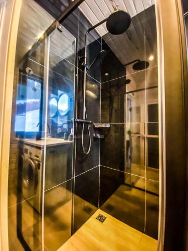 a bathroom with a shower with a glass door at GUKHOUSE in Huklyvyy