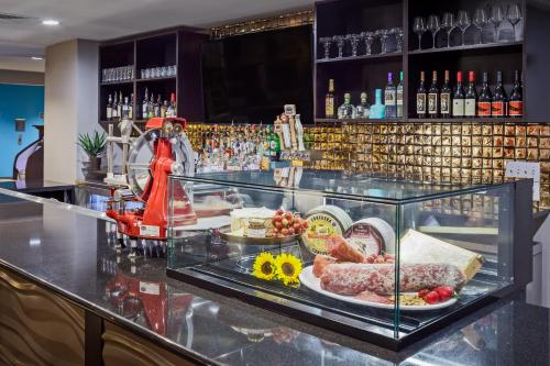 a bar with a plate of food on a counter at Hotel Indigo San Antonio Riverwalk by IHG in San Antonio