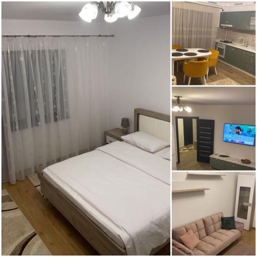 a bedroom with a bed and a kitchen and a table at Grant Apartament in Arad