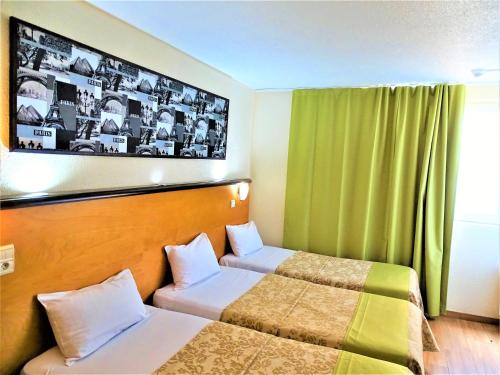 a hotel room with two beds and a window at Euro Hôtel Paris Créteil in Créteil
