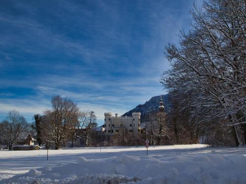 a building in the middle of a snow covered field at Gästehaus Marzoll in Bad Reichenhall