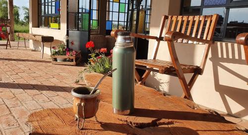 a green water bottle sitting on a table next to a chair at Campo dei Miracoli in Villa Lía