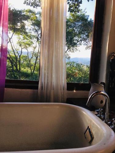 a bathroom with a bath tub and a window at Namasté Casa Rural in Vaqueros
