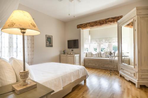 a bedroom with a white bed and a window at LuCe Design Hotel - Special Category in Alacati