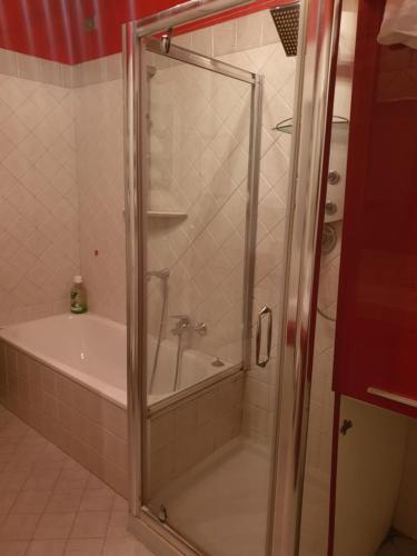a shower with a glass door in a bathroom at Apartment Airport in Bergamo