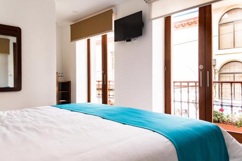 A bed or beds in a room at REEC Latacunga by Oro Verde Hotels