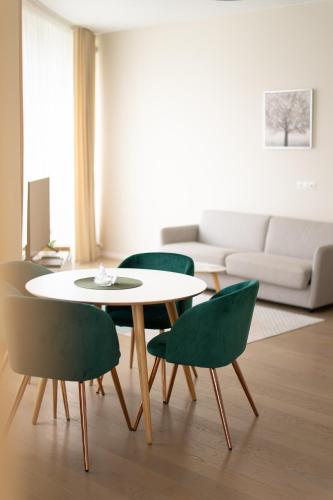 a living room with a table and four chairs at Apartment in Druskininkai City Centre in Druskininkai