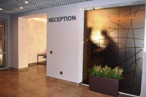 a lobby with a reception sign on the wall at Отель Сочи in Sochi