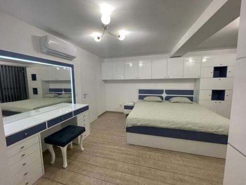 a bedroom with a bed and a desk and a mirror at Emily & Nasi in Plovdiv