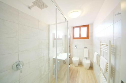 y baño con ducha, aseo y lavamanos. en DolceVita Apartments N 285 en Venecia