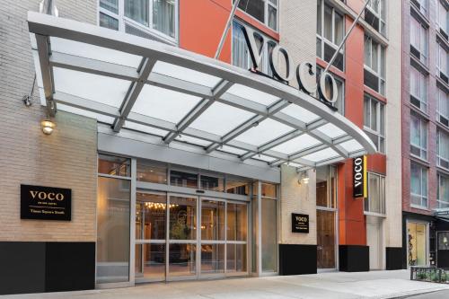 a building with awning over the entrance to a store at voco Times Square South, an IHG Hotel in New York