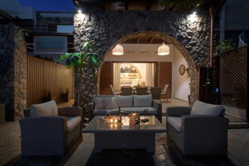 a living room with couches and a table at Villa Haraki Paradise in Haraki
