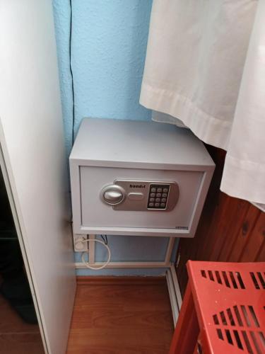 a small white box sitting on a stool in a room at Éva Apartmanház in Eger