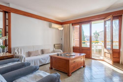 a living room with a couch and a coffee table at BRESSOL DELUXE Apartments in Port de Pollensa