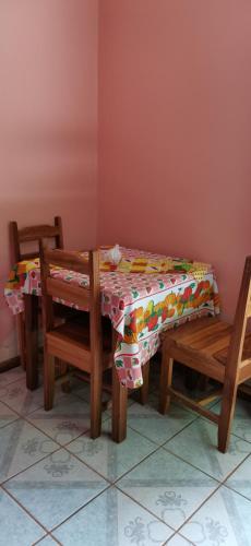 a table and two chairs and a table with a tablecloth at Cabinas Mitchaelle's in Puerto Viejo
