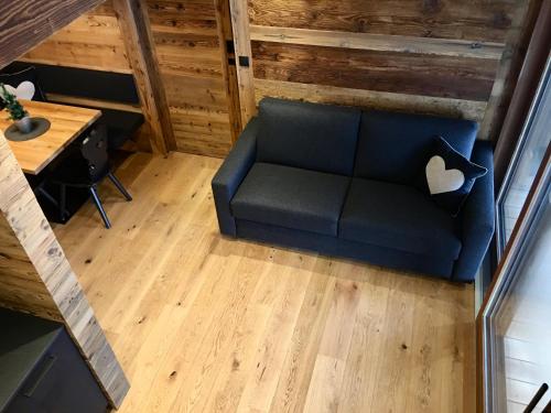 an overhead view of a couch in a room with a table at Appartements Innerkofler Mountain Home in San Candido