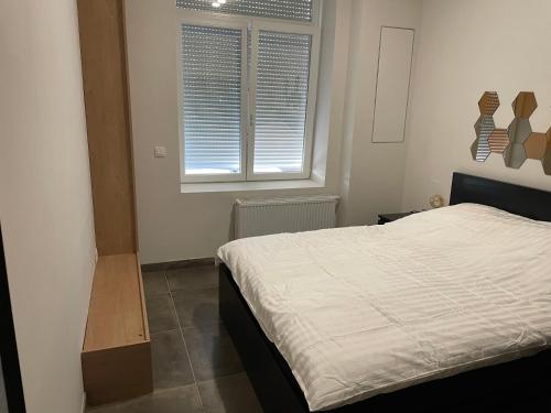 a bedroom with a bed and a window at Room of Tournai in Tournai