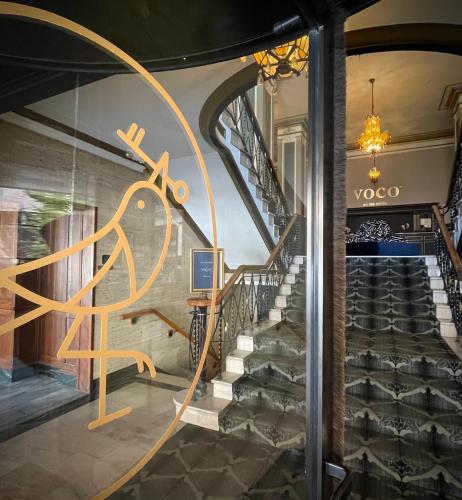 a spiral staircase in a building with a lobby at voco The Tiger Hotel, Columbia, MO by IHG in Columbia