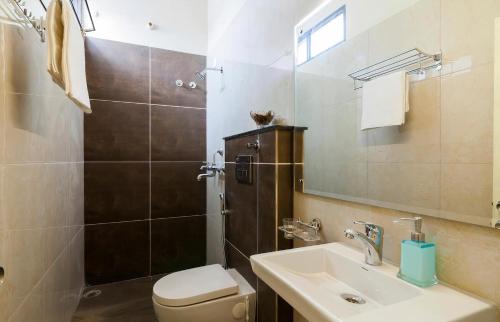 a bathroom with a toilet and a sink and a shower at The Buddhayan Villa in Jaipur