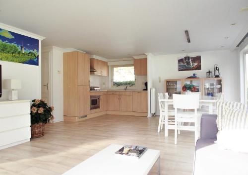 a living room with a kitchen and a dining room at Chaletparc Krabbenkreek Zeeland - Chalet 84 in Sint Annaland