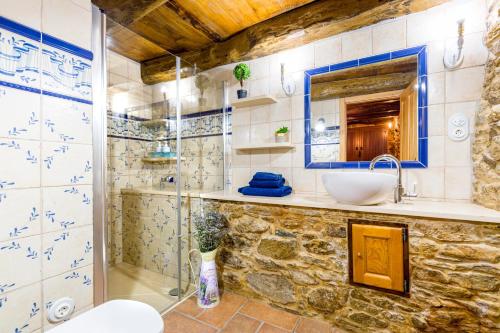 a bathroom with a glass shower and a sink at A casa de López in A Coruña