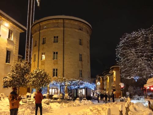 a building with christmas lights in front of it at Torrione Trento in Trento