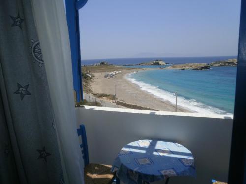 a view of a beach from a room with a window at Blue and White Studios & Apartments in Lefkos Karpathou