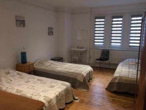 a hospital room with two beds and a window at Appartement - Villa " FERGINE" in Le Touquet-Paris-Plage